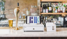 A restaurant bar, on the counter TouchBistro hardware and software.