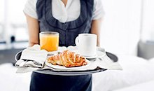 Server carrying a breakfast tray