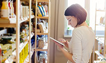 A woman checking her inventory list on her iPad