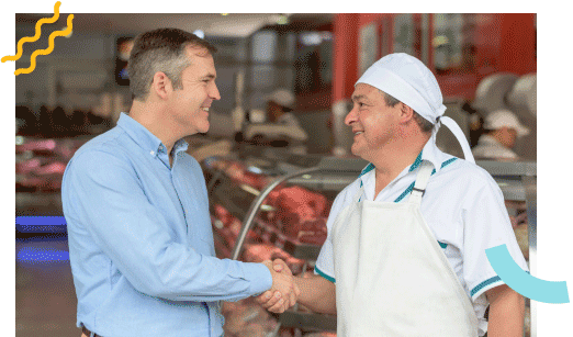 Men shaking hands in a butcher shop