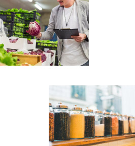 Man shopping for vegetables and a shelf of spices