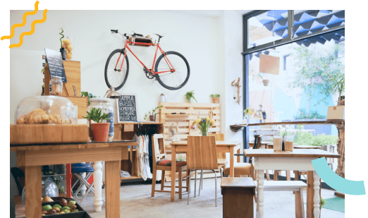 An empty café with a bike hanging on the wall as decorations.